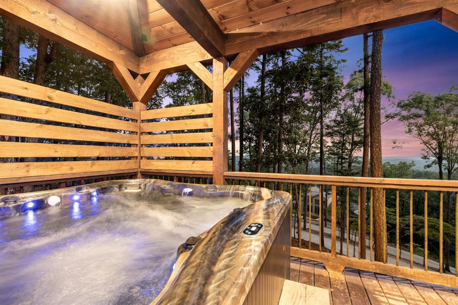 Private hot tub at sunset, on a screened porch above the tree line.